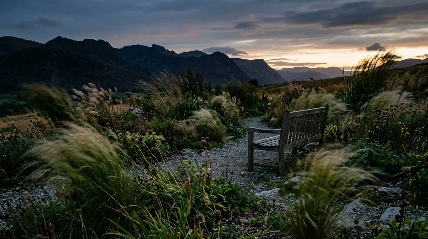 Breezy exposed Lake District garden at dusk with grasses bending in the wind, conditions that ground midges